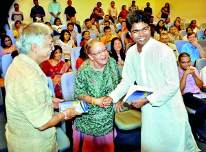 The 2012 Gratiaen Award winning novel 'Playing Pillow Politics at MGK' by Lal Medawattegedara was launched in November at the Lakshman Kadirgamar Institute for International Relations & Strategic Studies. Here the author presents a book to the US writers Ken and Visakha Kawasaki who were the language editors of the book. Pix By Mangala Weerasekera