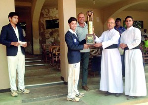Dylan Fernandopulle, captain of St Joseph's receiving the Murali-Vaas Trophy from Fr. Travis Grabriel, Rector St. Joseph's after defeating St. Anthony's by an innings and 35 runs at Darley Road yesterday