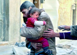 A boy holds his baby sister saved from under rubble, who survived what activists say was an airstrike by forces loyal to Syrian President Bashar al-Assad in Masaken Hanano in Aleppo February 14 (REUTERS)