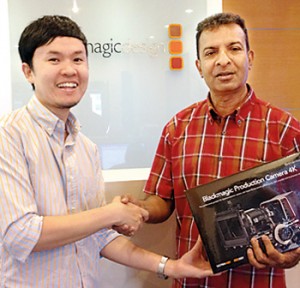 Blackmagic Asia Marketing Manager Gregory Chang handed over new camera to Rohan Welivita in Singapore