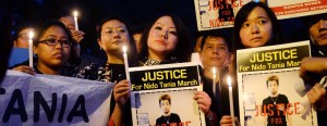 Indian students from the northeastern states and supporters hold placards and lit candles as they protest the death of northeastern student Nido Tania in New Delhi (AFP)