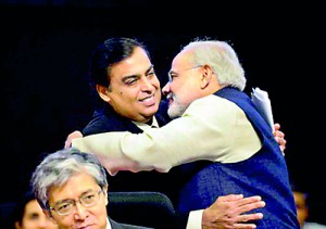 Narendra Modi greets Chairman and Managing Director, Reliance Industries Ltd. Mukesh Ambani on the launch of Vibrant Gujarat in 2013 (AFP)