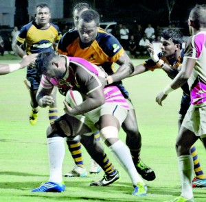 A Havelocks player tries to barge through an Army defender.  Pic by Ranjith Perera
