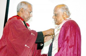 Dr Palitha Abeykoon (right) being inducted as the SLMA president by Dr B.J.C.Perera. Pix by Indika Handuwala