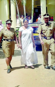 A school principal being brought to court in Matale. She is charged with soliciting bribe to admit a child to Grade 1. Pic by Mahesh Keerthirathna