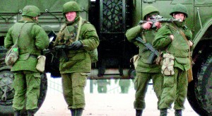 Unidentified soldiers block a road to Ukrainian military airport Belbek not far from Sevastopol on February 28, 2014. Ukraine accused Russia of staging an “armed invasion” of Crimea on Friday and appealed to the West to guarantee its territorial integrity after pro-Moscow gunmen took control of the peninsula's main airport. Unidentified armed men were patrolling outside of Crimea's main airport early Friday while gunmen were also reported to have seized another airfield on the southwest of the peninsula where ethnic Russians are a majority and where pro-Moscow sentiment runs high.   AFP PHOTO/ VASILIY BATANOV