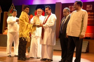 Picture shows the President handing over one of the awards.