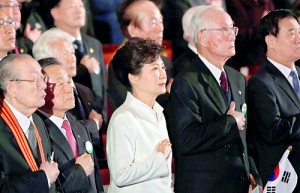 South Korea's President Park Geun-hye (C) salutes the national flag during a ceremony celebrating the 95th anniversary of the March First Independence Movement against Japanese colonial rule, in Seoul (AFP)