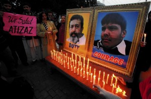 A vigil in Pakistan honours Aitzaz Hassan (photo on right), who was killed Jan. 6 after tackling a suicide bomber who was about to enter his school. The other photo shows Pakistani policeman Superintendent Chaudhry Aslam, who was killed in a separate bomb attack in January (REUTERS)