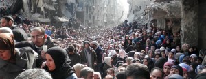 Syria's starving population: Hundreds of men, women and children gathered amid the rubble of Damascus for UN food hand-outs after being cut off for months. The United Nations Relief and Works Agency (UNRWA) called on rebel forces and Assad’s troops alike to allow ‘safe and unhindered humanitarian access’ to civilians in Yarmouk, a Palestinian district in the Syrian capital ( Reuters)
