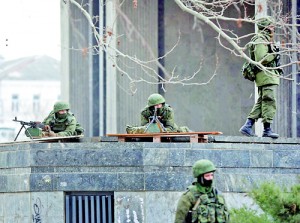 Armed men take up positions around the regional parliament building in the Crimean city of Simferopol