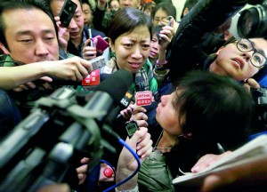 A woman, whose husband is a passenger of Malaysia Airlines flight MH370, complains about Malaysia Airlines to journalists as she attempts to leave a hotel in Beijing, March 8, 2014. The flight carrying 227 passengers and 12 crew went missing over the South China Sea today presumed crashed, as ships from countries closest to its flight path scoured a large search area for any wreckage (REUTERS)
