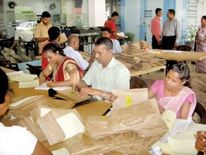 Getting ready for postal voting: Postal Dept  officials at the Kalutara Secretariat. Pic by Sunil Tantiriarachchi