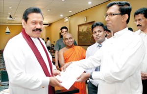The first copy of The Jathika Hela Urumaya's programme of action being handed over to President Mahinda Rajapaksa on Friday by JHU Media Secretary Nishantha Warnasinghe, and candidate for the Western Provincial Council polls.