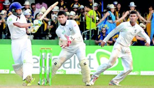 Captains in action: Royal skipper Chamika Karunaratne pulls while his Thomian counterpart Madushan Ravichandrakumar (R) reacts swiftly