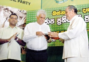 Karu Jayasuriya UNP Leadership Council chairman hands over the party’s maniffesto to party Leader Ranil Wickremesinghe. Pic by Nilan Maligaspe