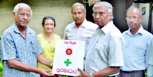 Mr. D.D.S. Jayawardene who donated the funds for the project is seen here handing over the First Aid Boxes to Red Lotus President Deshabandu Olcott Gunasekera.