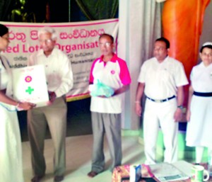 Distribution of First Aid Boxes to the trainees by Red Lotus president Deshabandu Olcott Gunasekera. Red Lotus executive committee member Capt. Buddhadasa Weliwatta is also in the picture