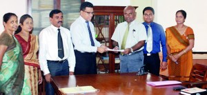 CDA Chairman Aruna Gunawardena(left) handing over the contract document to Cyber Concepts CEO Ravi Rajapathirane in the presence of Arosh Somatilleka, Manager Operations, Ms. Jina Rajapathirane, Director -Cyber Concepts  M.P.N.M. Wickramasinghe, Director General, Ms. S. Rajakaruna, Director and  Ms. Wasula Herath, Assistant Director of CDA.
