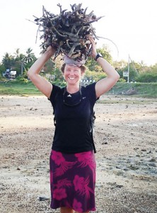 Sandy helps a woman by carrying her firewood at Kirinda