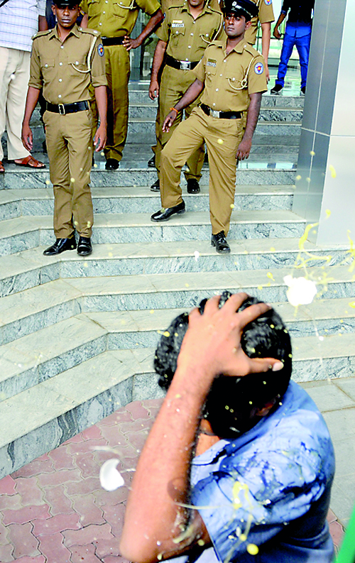 Coming under an egg attack as police look on during the recent Hambantota incident 