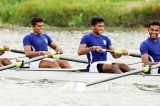 Navy men and Army women row through