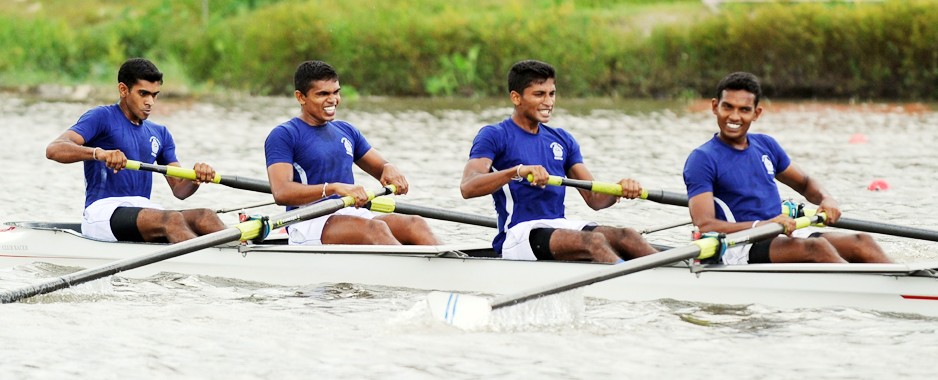 Navy men and Army women row through