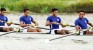 Navy men and Army women row through