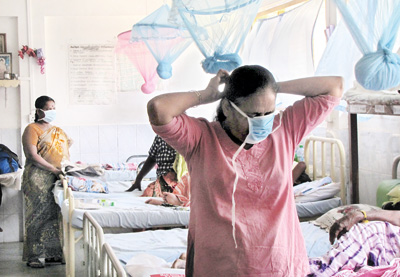 Emergency: Masks come up as virus spreads With the influenza virus spreading all over the country and the death toll rising to 32, emergency precautionary measures are being taken as shown in this picture with visitors to Vavuniya Hospital wearing masks. Pic by Priyantha Hewage