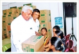 Pragna Pradeepa distributes schoolbooks to flood-affected children