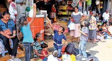 School children playfully await Perahera