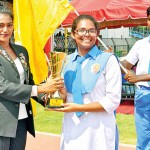 Sprinter Nadeeshani Handerson, the chief guest handing over the overall trophy to Peter House captain