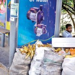 A vendor appears to have set up shop at this bus halt with chairs amid his garbage collection