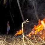 Villagers light fires around their abodes