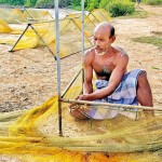 Mending ways: A fisherman tends the tools of his trade