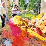 Officials examine the haul of illegal nets