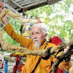 Vietnam Nguyen Van Chien, 92, sits for a portrait to show his 5-metre long hair which, according to him, has not been cut for nearly 80 years,  at his home in  Tien Giang province. - Sources: The Guardian/ Reuters/ AFP