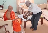 Prof Karunadasa hands over copy of new book to Anunayake Thera