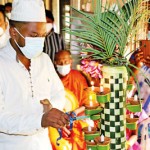 Lighting the oil lamp by the priest