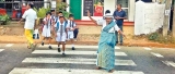 At 84 ‘traffic aachchi’ still helps schoolchildren cross the road