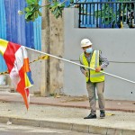 Havelock Town - Construction break: A Chinese worker hoists the Budhist flag  Pix by Eshan Fernando