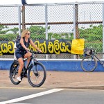 Things to see: A tourist rides by the protest site