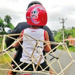 Dambulla- Sparse trimmings: A child takes home two lantern frames Pic by Kanchana Kumara Ariyadasa