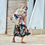 Kirulapone: Heavy burden: A woman holds her haul of firewood close