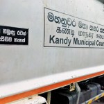 Kandy - Fall from grace: An old campaign poster on a municipal dump truck Pic by L B Senaratne