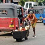 Panchikawatte-Dual-purpose vehicle: A man pushes a child in a  goods cart