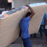 Maligawatte- Transport costs: A man carries a mattress Pix by Akila Jayawardena