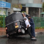 Rajagiriya- Push start: Changing a flat tyre in the rain             Pix by Eshan Fernando