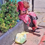 Colombo:  Two tales of one city, A woman weighed down by poverty, loneliness (left ) and  (right)  Condominiums  skyrocketting as high as the country's COL  Pix by H.K.Wijeratne