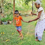 Karuwalagasweva  World Children's and Elder's Day: A boy helps his grandmother  Pic by Jayarathna Wikramaarachchi